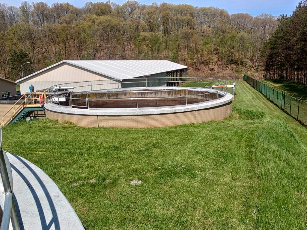 Industrial circular steel tank structure with safety railings installed at a facility by Mobile Welding Solutions in Pennsylvania