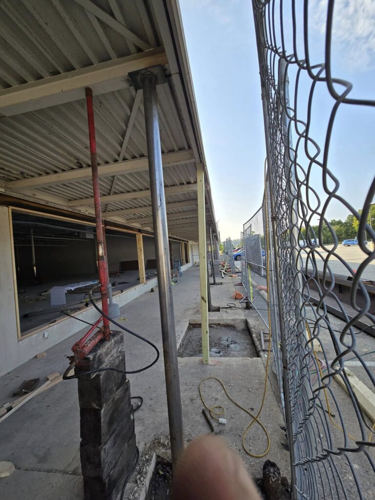 Structural steel support column installed during a commercial storefront renovation and building reinforcement project in Pennsylvania.
