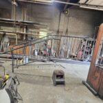 Custom steel handrail fabrication and welding project in a metal fabrication shop for commercial stair access systems.