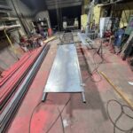 Custom steel loading ramp and equipment platform under fabrication in a Pennsylvania welding shop.