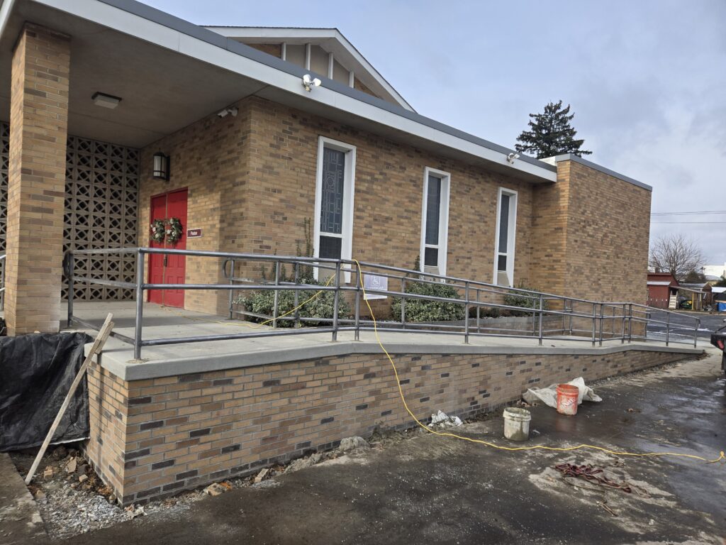 ADA accessible ramp with custom steel handrails installed at commercial building in Pennsylvania