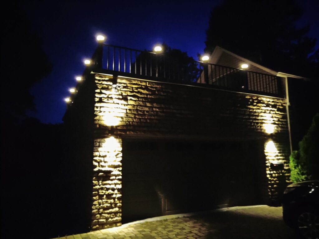 Custom welded steel railing installed on elevated deck with lighting at night in Pennsylvania