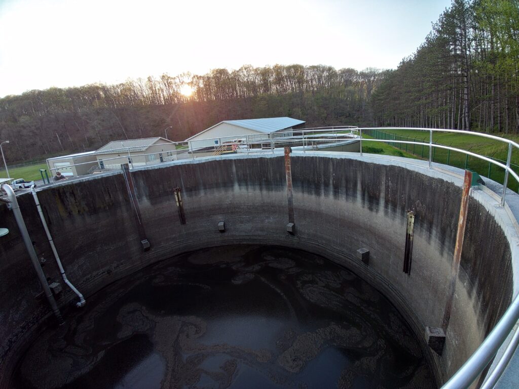 Circular industrial tank with stainless steel safety railing installed at facility in Pennsylvania