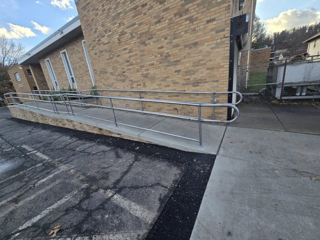 ADA compliant commercial access ramp with stainless steel handrails installed in Pennsylvania