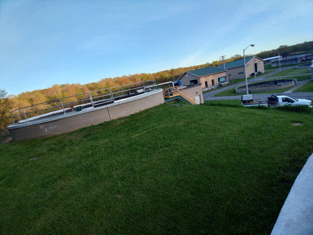 Steel safety railing installed around industrial treatment tank