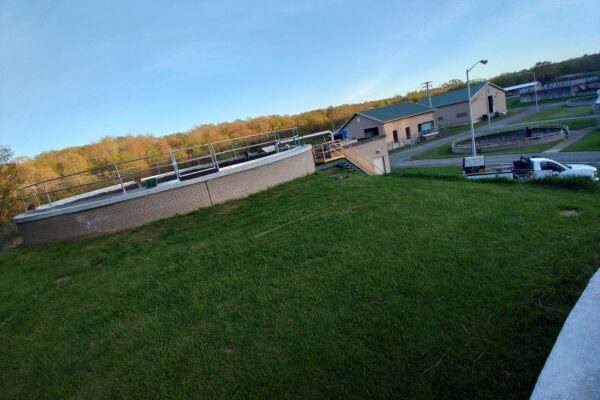 Steel safety railing installed around industrial treatment tank