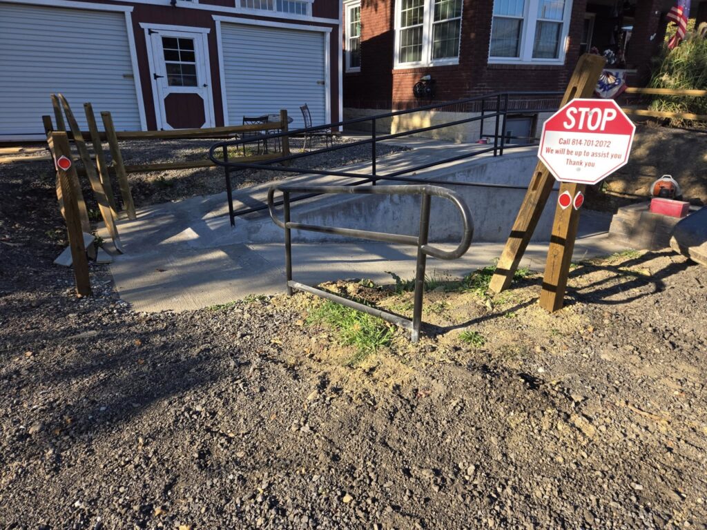 Custom steel ADA handrail installed along concrete accessibility ramp in Pennsylvania