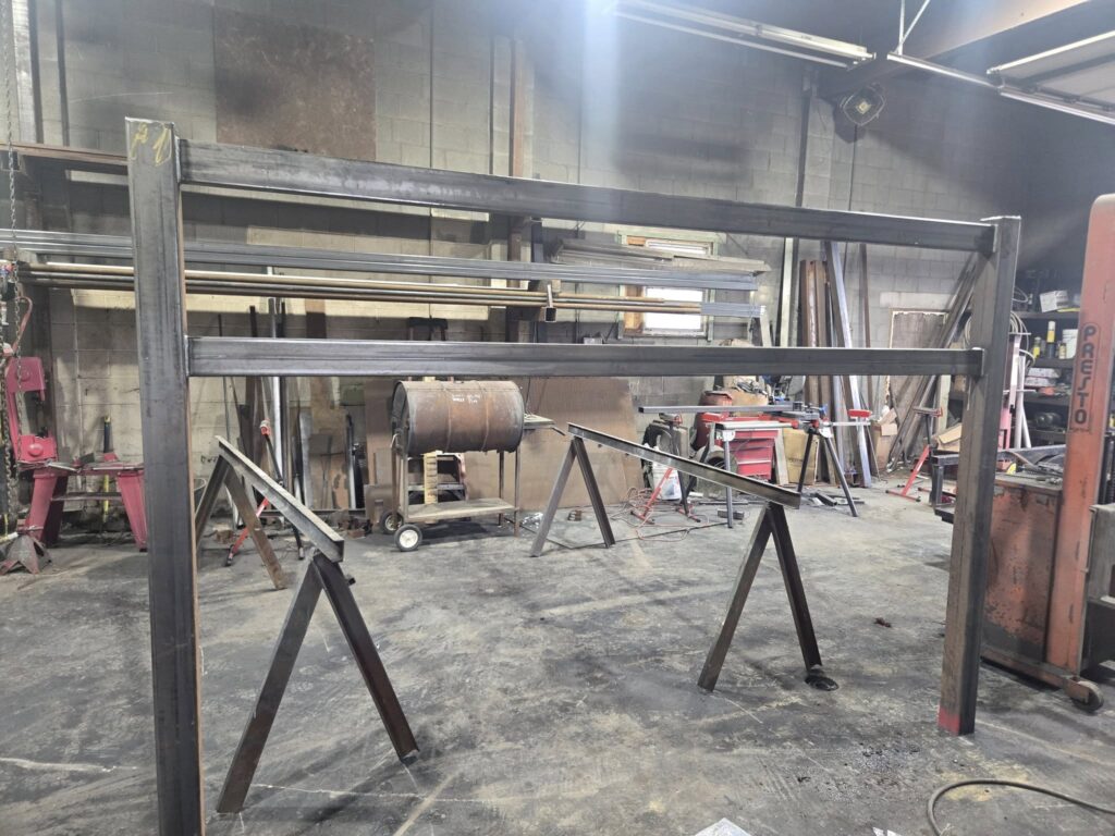 Custom heavy structural steel frame fabricated inside welding shop