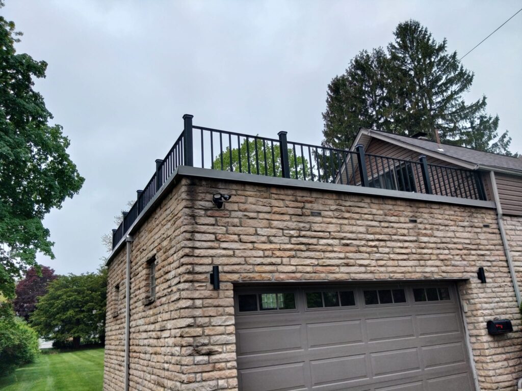Custom steel railing installed on residential rooftop deck