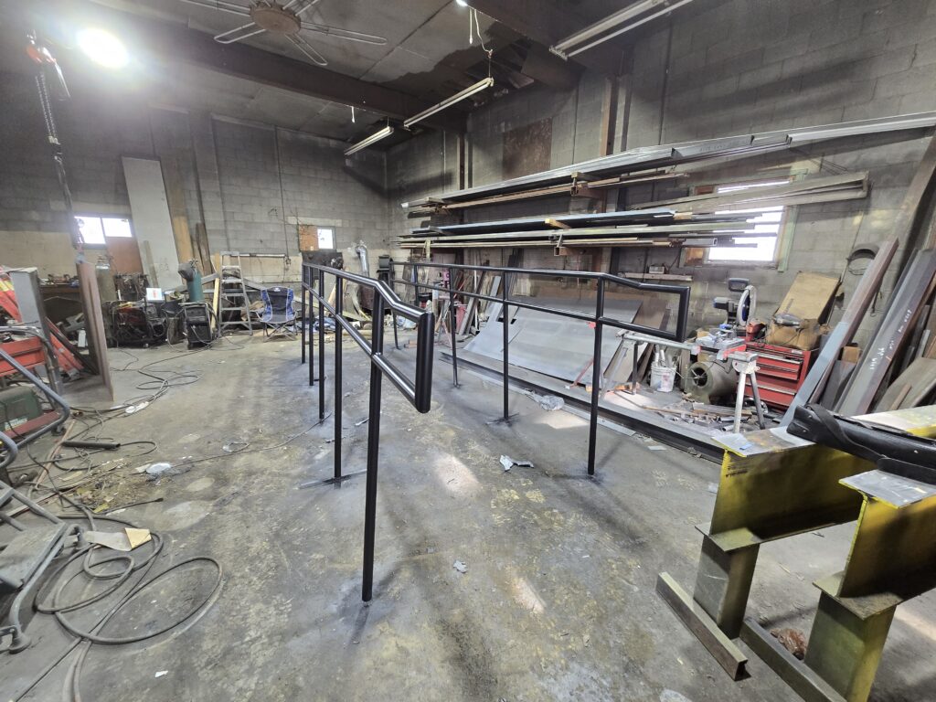 Custom steel handrail system fabricated inside welding shop