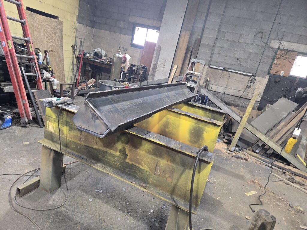 Custom steel hopper and container fabrication in metal shop