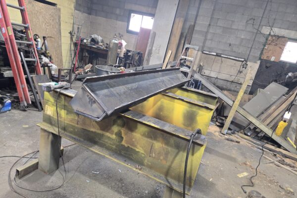 Custom steel hopper and container fabrication in metal shop