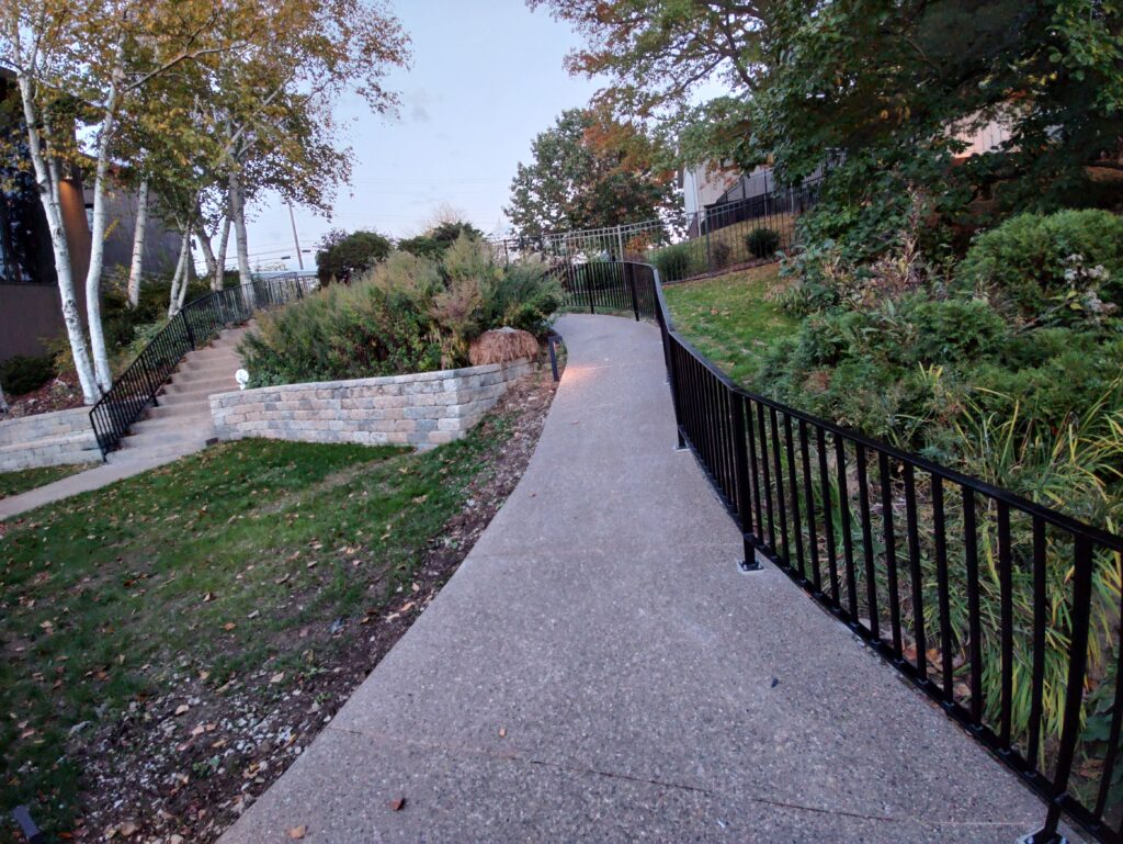 Custom steel handrail installation along concrete walkway in Pennsylvania