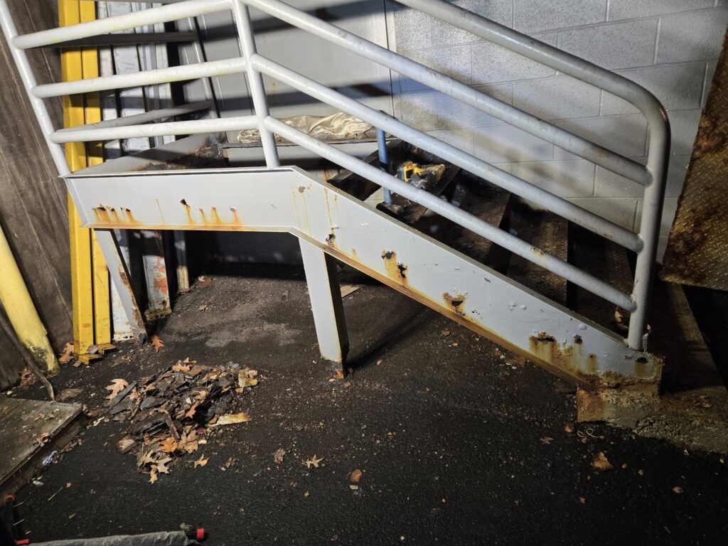 Steel staircase structure repair with welded support frame