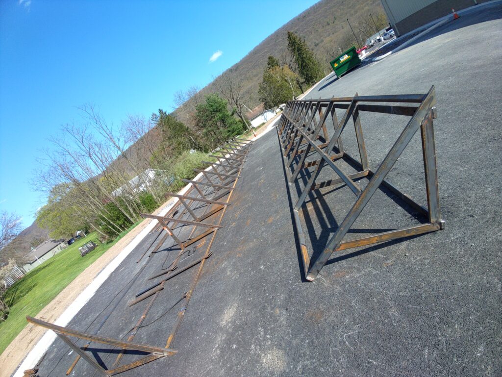 Custom fabricated steel truss frames prepared for installation