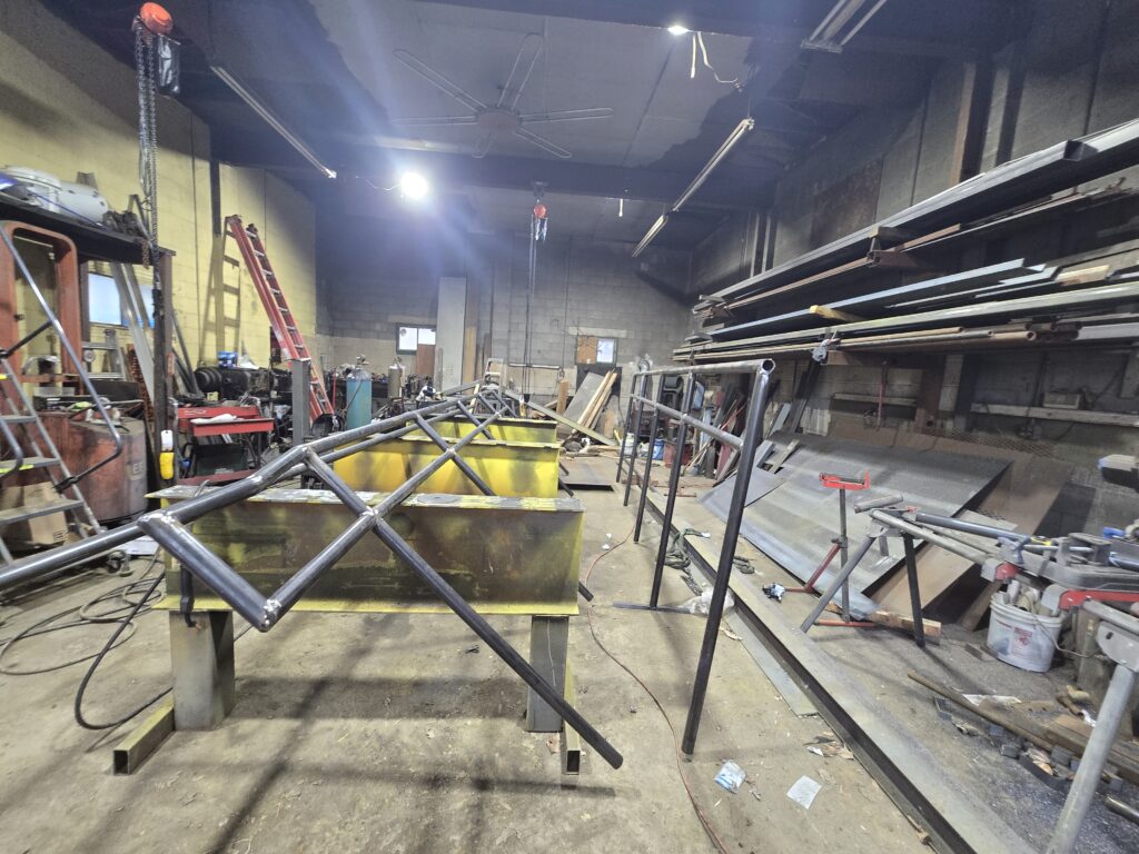 Custom steel truss frame fabricated inside metal workshop