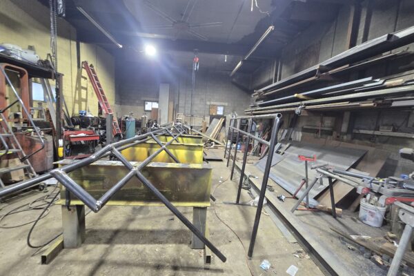 Custom steel truss frame fabricated inside metal workshop