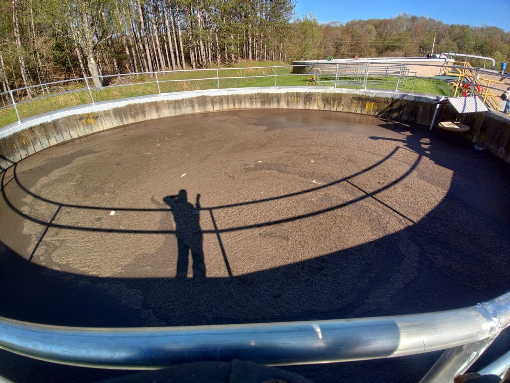 Industrial wastewater treatment tank with custom steel safety railing