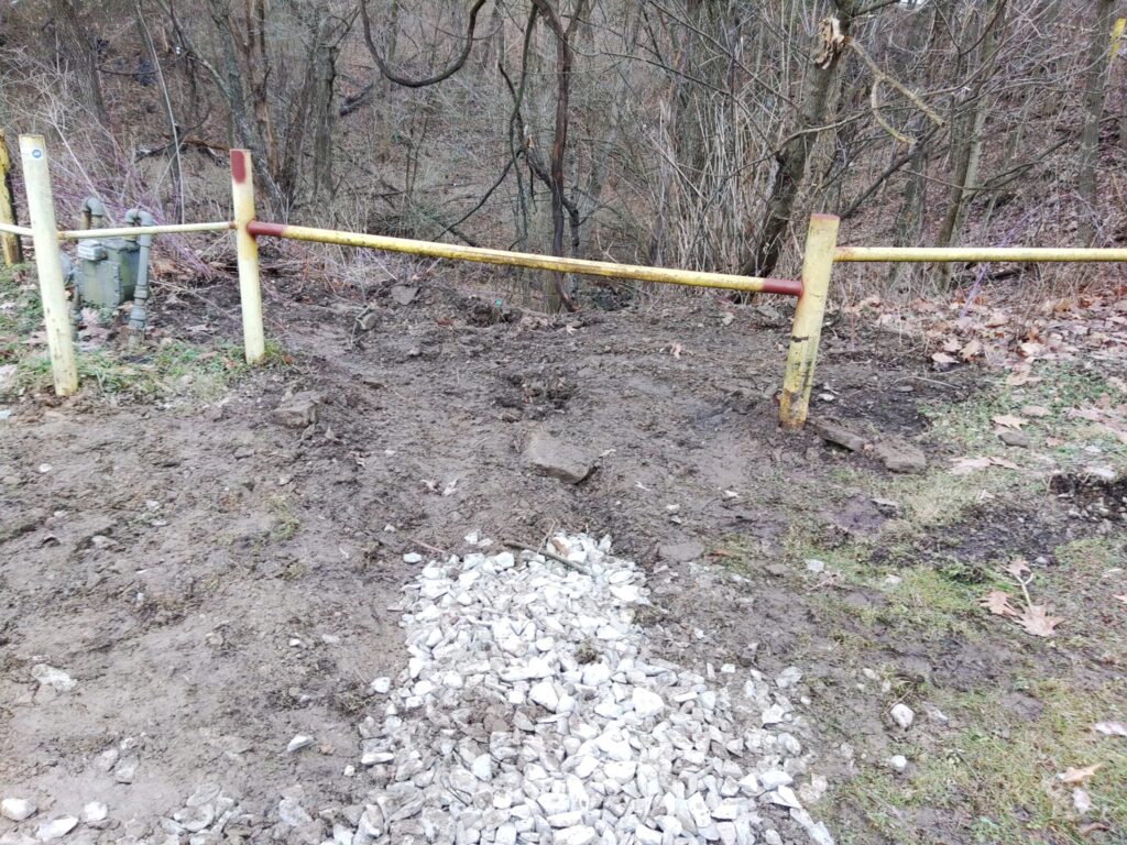 Steel safety barrier posts installed along hillside edge