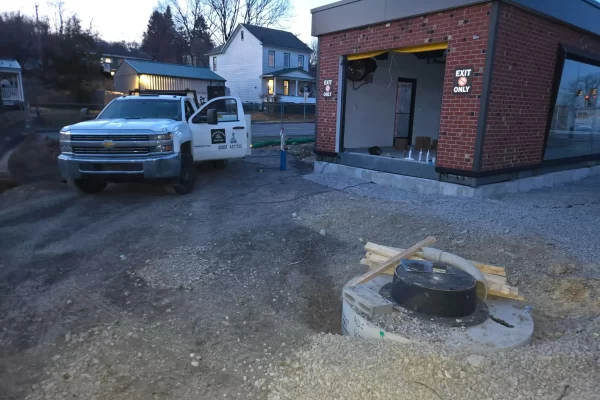 Structural steel base supports installed around a commercial brick building in Pennsylvania.