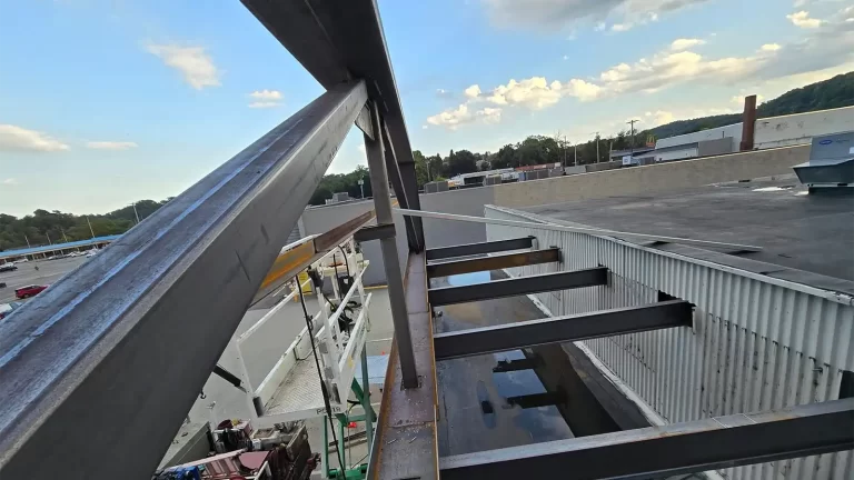 Commercial structural steel canopy extension and beam installation for retail storefront expansion project.