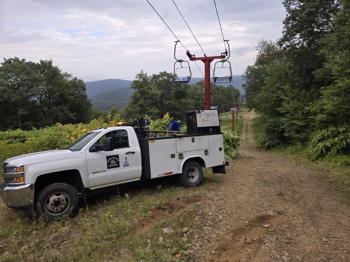 Mobile Welding Solutions service truck providing heavy equipment welding repair at a ski lift in Pennsylvania